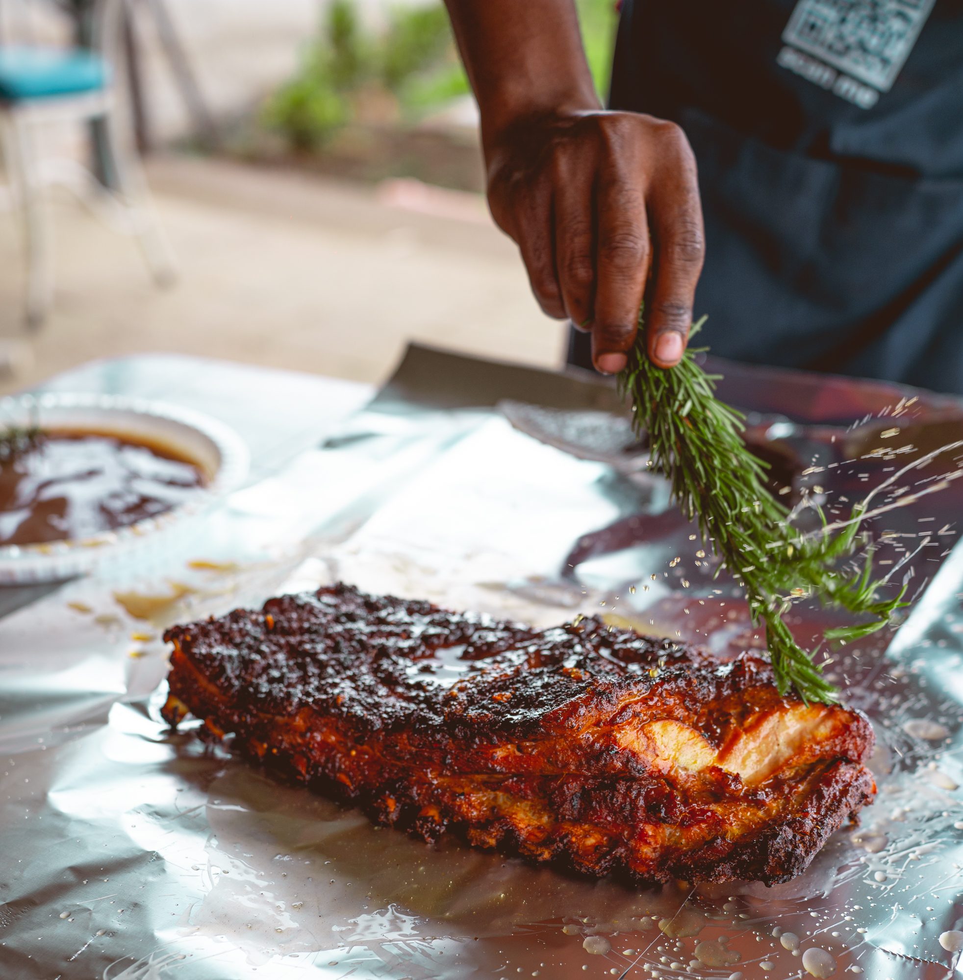 Wood-smoked pork spare ribs with rosemary at a Nairobi BBQ event
